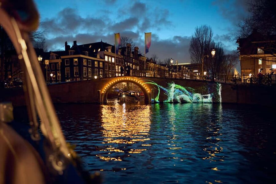 Amsterdam: Light Festival Boat with Hot Choco & Stroopwafel - Haarlemmersluis and the changing city view