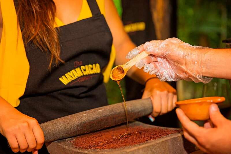 Cozumel: Chocolate Workshop at The Mayan Cacao Company - Grinding cacao on a traditional metate